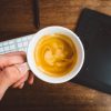 image of hand holding a cup of coffee with pumpkin spice creamer dairy free by intentionally eat
