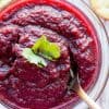 jalapeno cranberry sauce in a glass bowl with a spoon