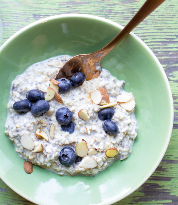 image of simple overnight oats by Intentionally Eat with Cindy Newland in a green bowl with a gold spoon and blueberries