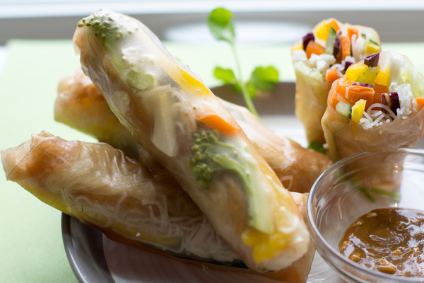 image of Easy Spring Rolls by Intentionally Eat on a plate with a bowl of peanut dipping sauce