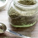 Homemade Dry Ranch Seasoning Mix by Intentionally Eat with Cindy Newland in a glass jar with a silver tablespoon