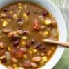 Taco Soup in a white bowl with a gold spoon