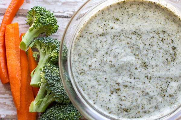 dairy free healthy ranch dressing by intentionally eat with Cindy Newland in a glass bowl with broccoli and carrots