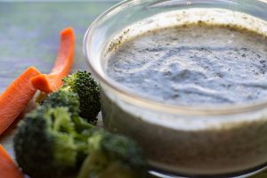 dairy free healthy ranch dressing by intentionally eat with Cindy Newland in a glass bowl with broccoli and carrots