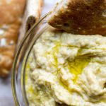 image of Easy Baba Ganoush-roasted eggplant dip by intentionally eat with Cindy Newland in a glass bowl with pita bread