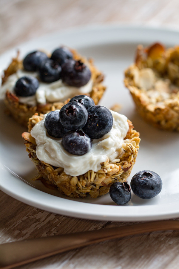 image of Quick and Easy Granola Cups by Cindy Newland with Intentionally Eat on a white plate with yogurt and blueberries