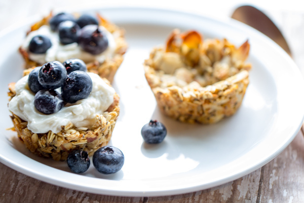 image of Quick and Easy Granola Cups by Cindy Newland with Intentionally Eat on a white plate with yogurt and blueberries