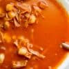 image of Jackfruite Red Pozole by Cindy Newland with Intentionally Eat in a white bowl with a gold spoon