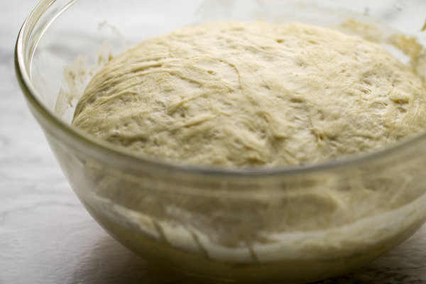 The Best Homemade Pizza Dough by Intentionally Eat with Cindy Newland in a clear glass bowl