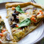 image of Homemade Greek Pizza by Intentionally Eat with Cindy Newland on a plate with a gold fork