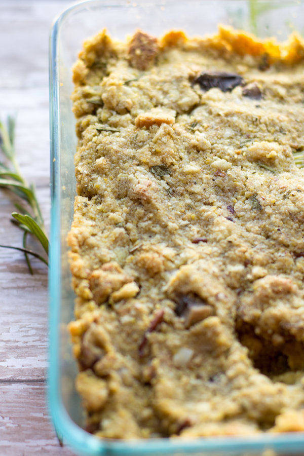 vegan stuffing in a glass dish with rosemary
