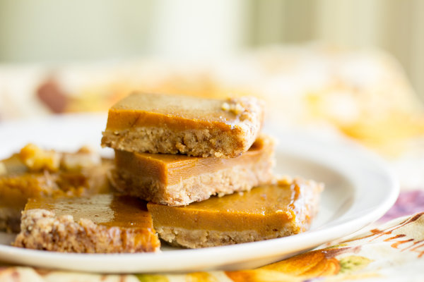 image of pumpkin pie bars with a gluten free crust by intentionally eat with cindy newland on a white plate