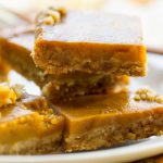 image of pumpkin pie bars with a gluten free crust by intentionally eat with cindy newland on a white plate