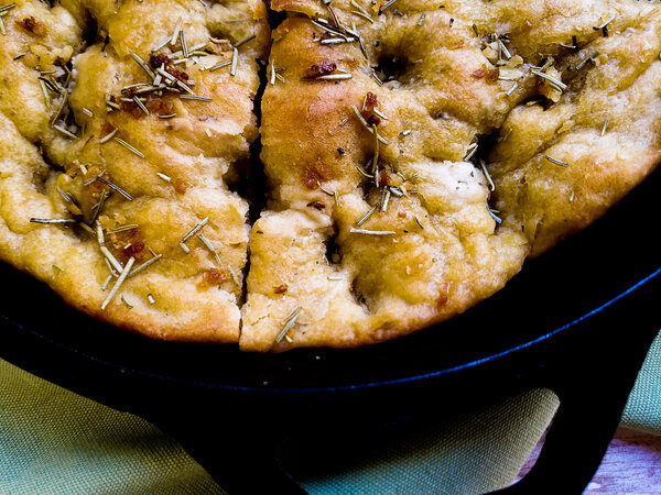 image of vegan no knead herb focaccia bread by Intentionally Eat with Cindy Newland in a cast iron skillet