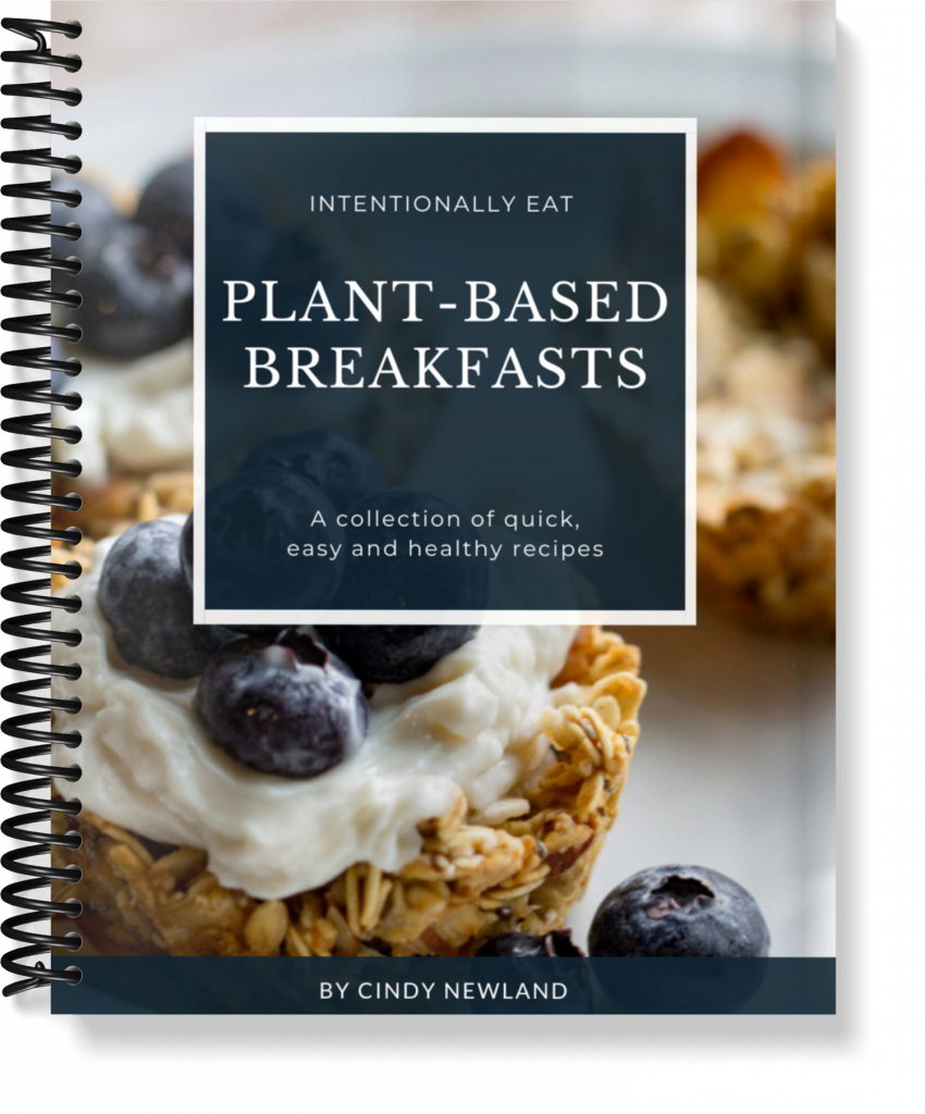image of the free plant based breakfast cookbook by intentionally eat on the cover are granola cups filled with non-dairy yogurt and blueberries