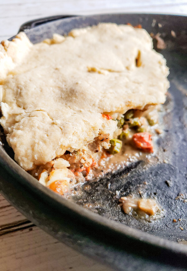 image of a slice of vegan chicken pot pie in a cast iron skillet