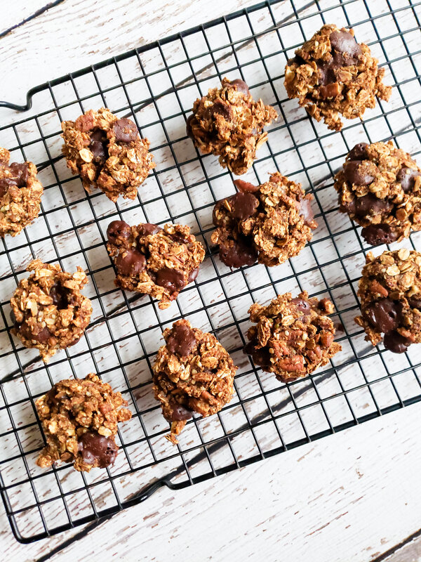 image of a dozen chocolate chip oatmeal vegan cookies on a cooling rack