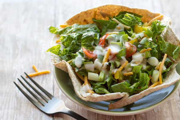 quick and healthy taco salad in a taco bowl with a fork next to it