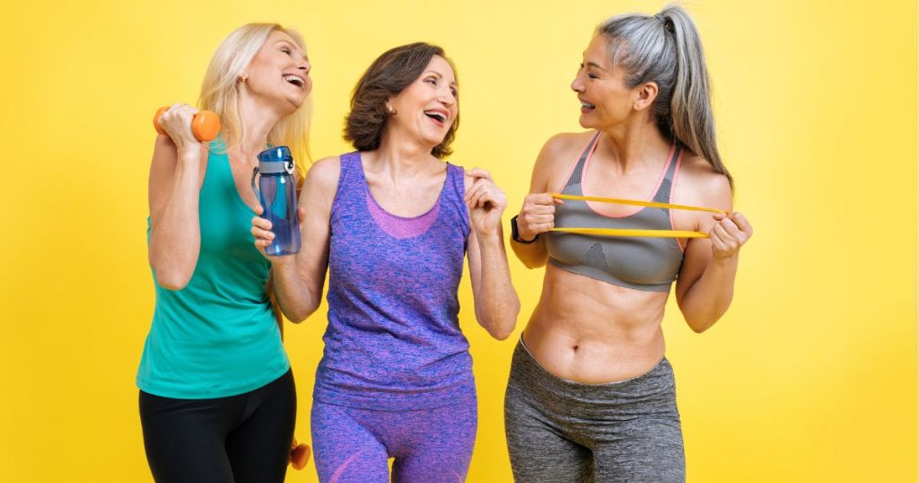 three healthy mid age women laughing