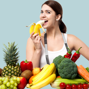 woman surrounded by produce while eating a banana
