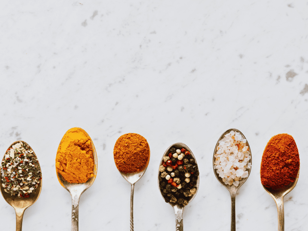 different spices in spoons