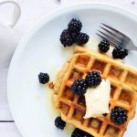 dairy free waffles with dairy free butter, maple syrup, and blackberries