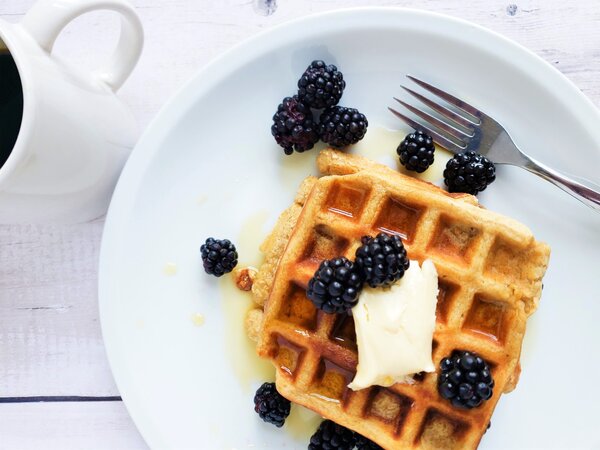 dairy free waffles with dairy free butter, maple syrup, and blackberries