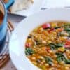 bowl of soup next to soup in a stock pot