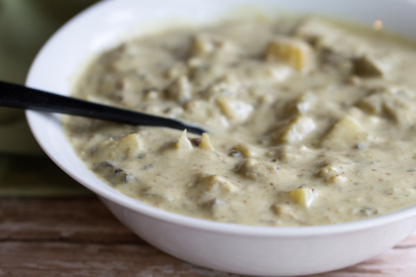 clam-less chowder in a white bowl with a spoon