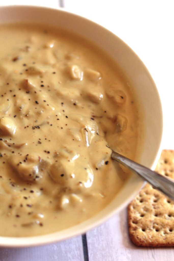 a bowl of dairy free mushroom soup with crackers