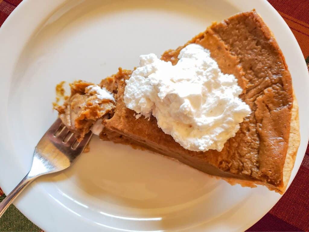 a slice of vegan sweet potato pie on a white plate