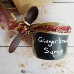 gingerbread syrup in a glass jar with wooden spoon