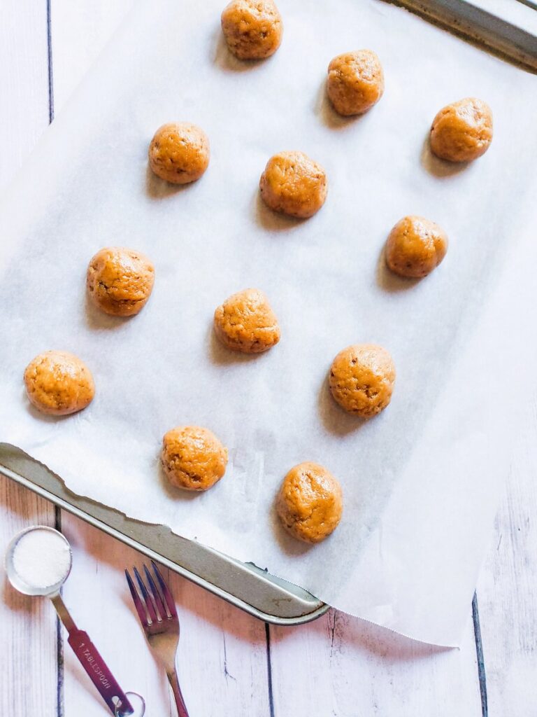 balls of sugar free peanut butter cookie dough on cookie sheet