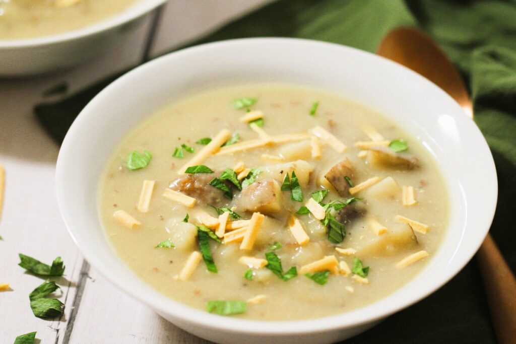 vegetarian potato soup in a white bowl