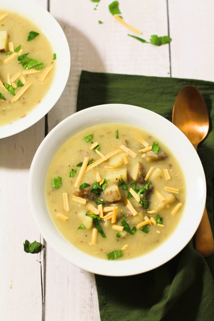 vegetarian potato soup in white bowls