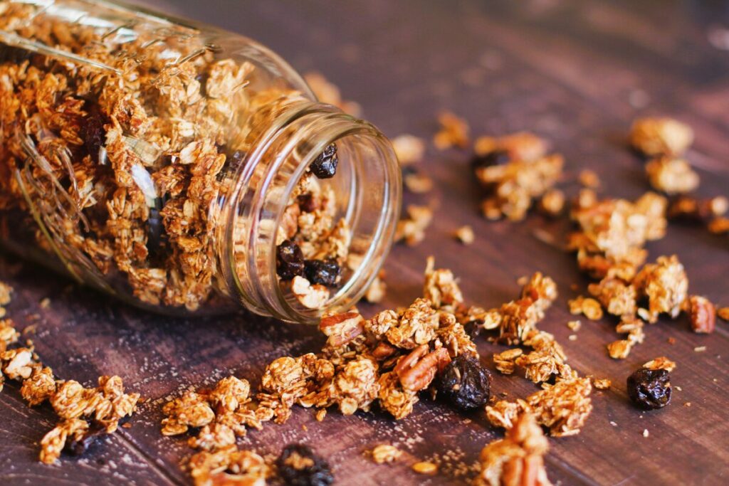 granola spilling out of a glass jar