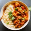 vegan potato curry in a bowl with a spoon