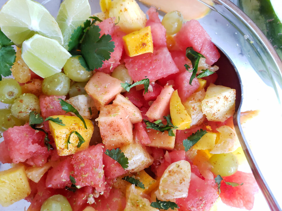 mexican fruit salad with chili powder in a glass bowl