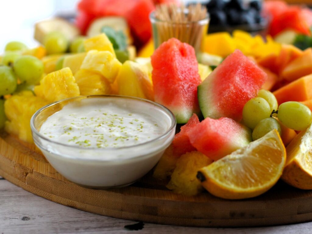 a bowl of creamy fruit dip and fruit