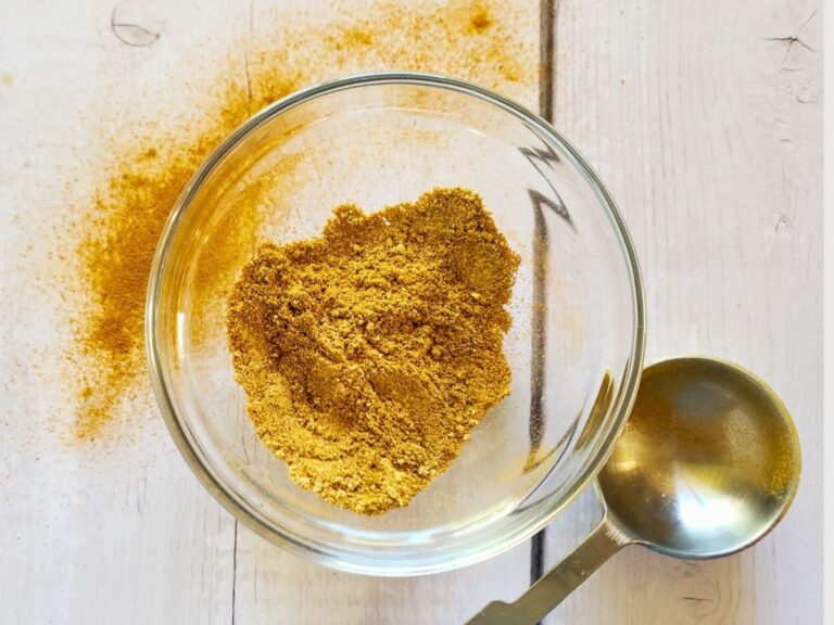 curry powder substitute in a small glass dish with a tablespoon