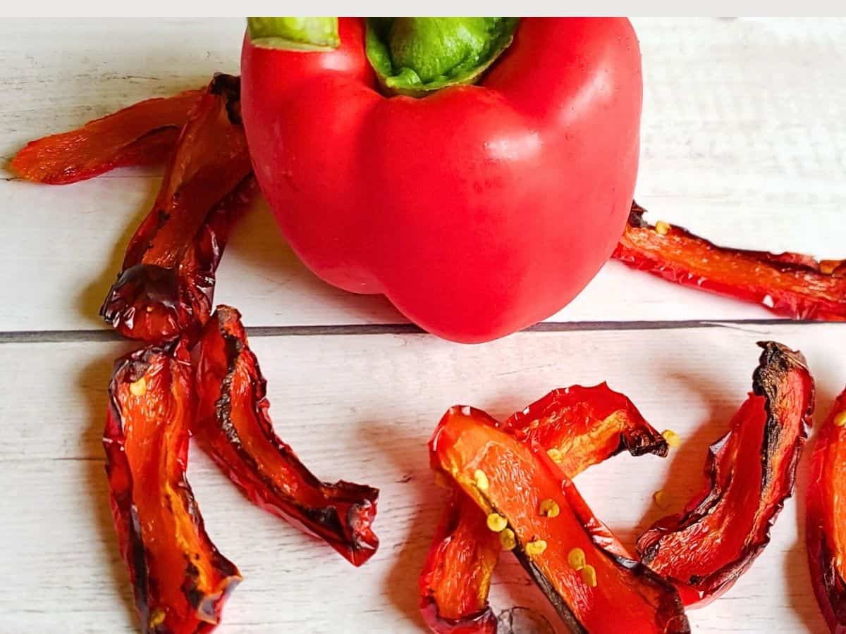 slices of roasted red pepper surrounding a red bell pepper