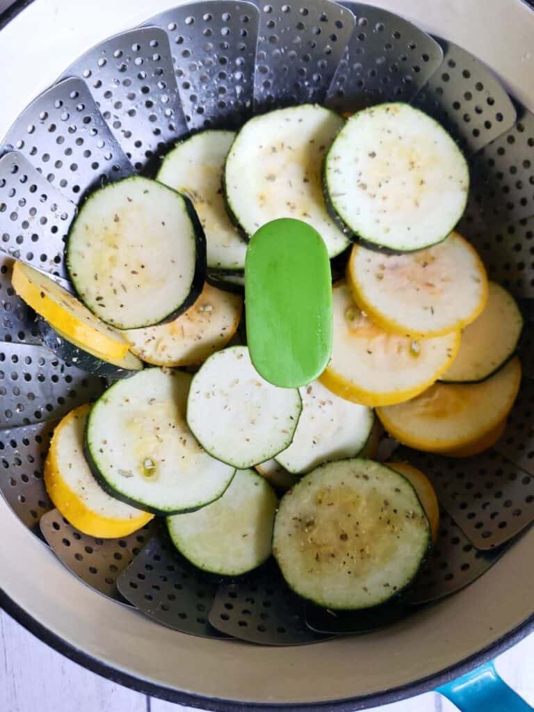 zucchini and squash in a steamer basket