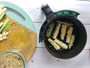 zucchini fries in an air fryer basket
