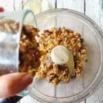 nuts being added to a food processor