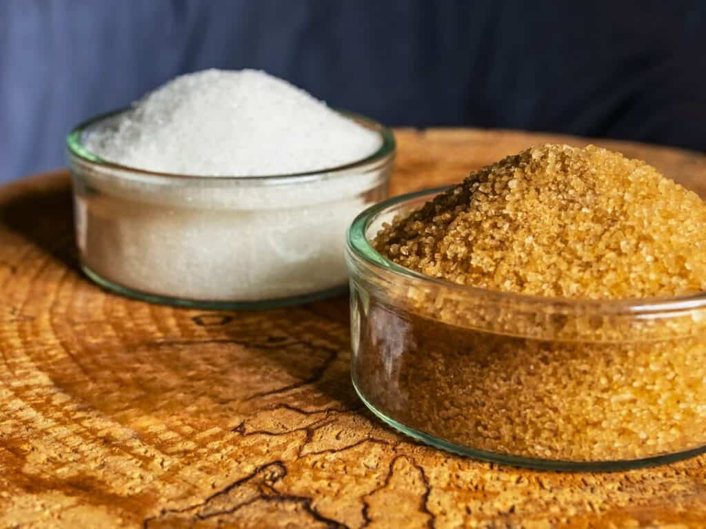 a bowl of allulose and a bowl of monk fruit sweetener