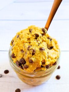 edible chocolate chip cookie dough in a glass jar with spoon
