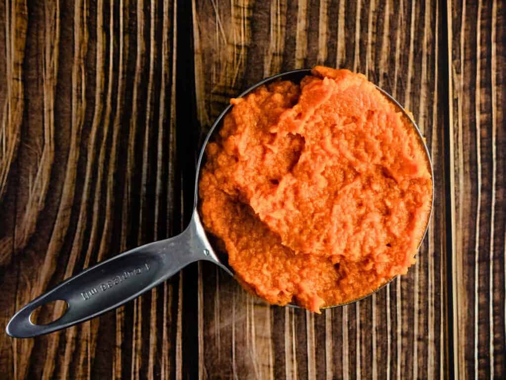 a measuring cup of pumpkin filling
