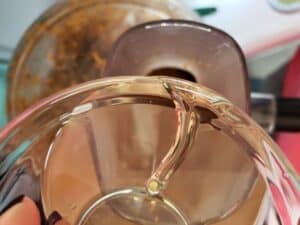 coconut oil pouring into food processor