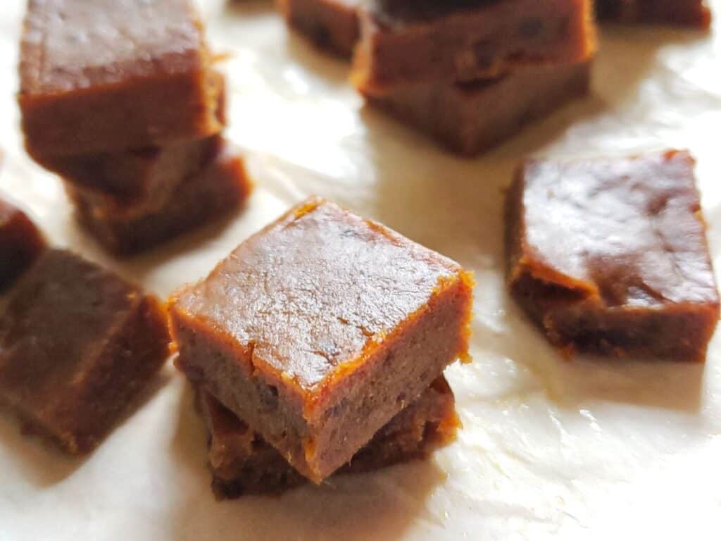 squares of pumpkin fudge on parchment paper