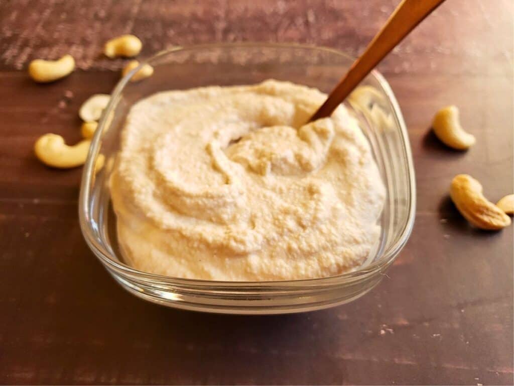 cashew cream in a bowl with a spoon